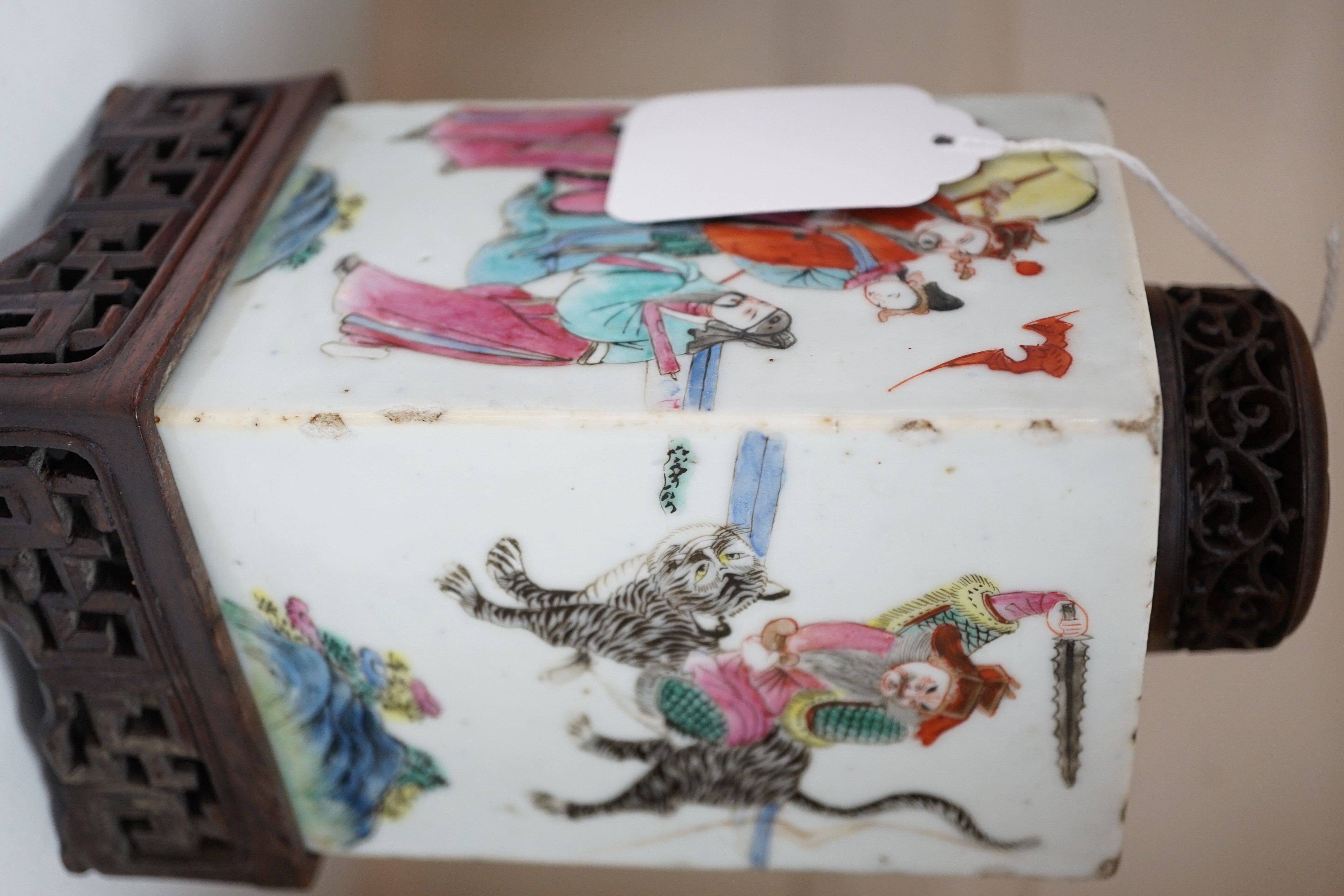A Chinese famille rose square tea caddy, mid 19th century, 13.7cm high excluding wood stand and cover, slight damage